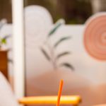 Colorful mint blue beverage with orange straw in a cozy cafe setting. Perfect summer refreshment.